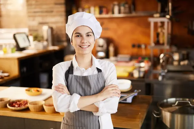 A welcoming chef, arms crossed